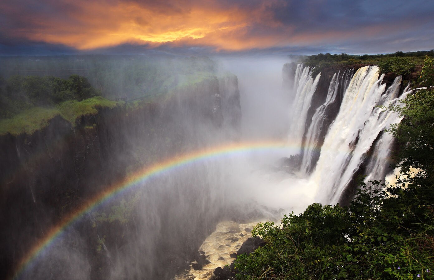 Victoria Falls sunset with rainbow Zambia shutterstock 129335261