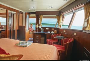 Lindblad Expeditions National Geographic Islander Accommodation Category 5 Living Area & Balcony.jpg