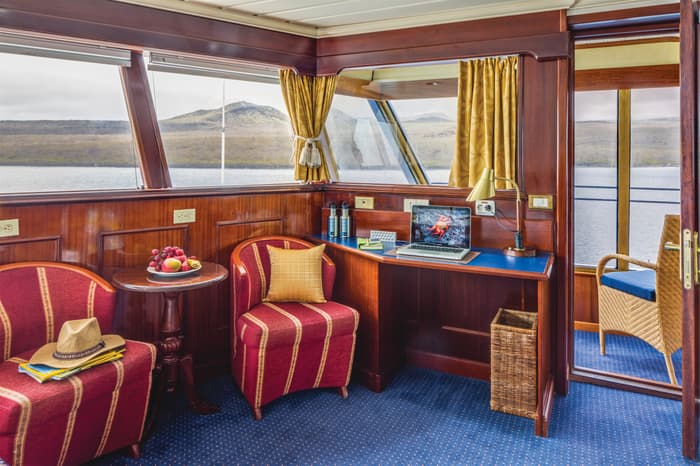 Lindblad Expeditions National Geographic Islander Accommodation Category 5 Living Room & Desk.jpg