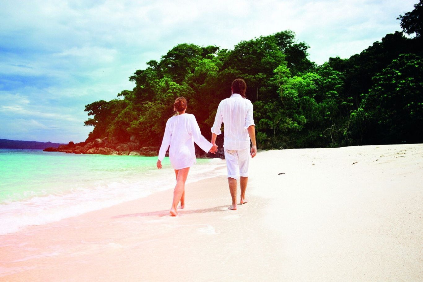 Couple walking on Caribbean beach