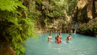 Family enjoying waterfalls of Dominican Republic Credit NCL