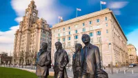 Visitors to Liverpool's waterfront are greeted by an iconic statue of the Fab Four. Credit: Shutterstock