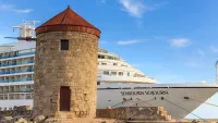 Discover Seabourn Sojourn docked next to UNESCO World Heritage Site stone windmills. Credit: Shutterstock