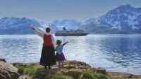 Hurtigruten waving from shore image Credit