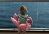 A happy toddler on her way to the pool