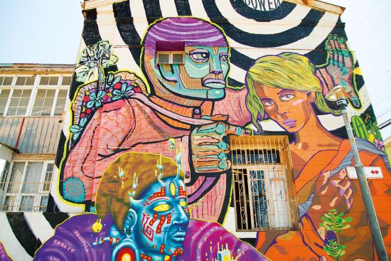 Colourful mural of man and woman showcasing Valparaiso's vibrant street art