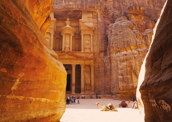 The cliff face and temple at Petra with camels