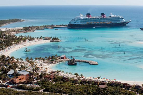 Disney cruise line's ship docked by Castaway Cay private island