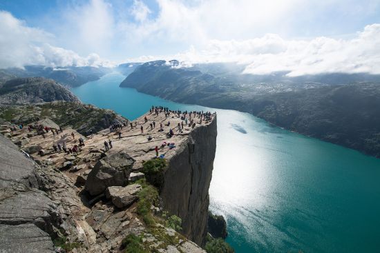 people standing on Cliff Preikestolen in fjord Lysefjord - Norway