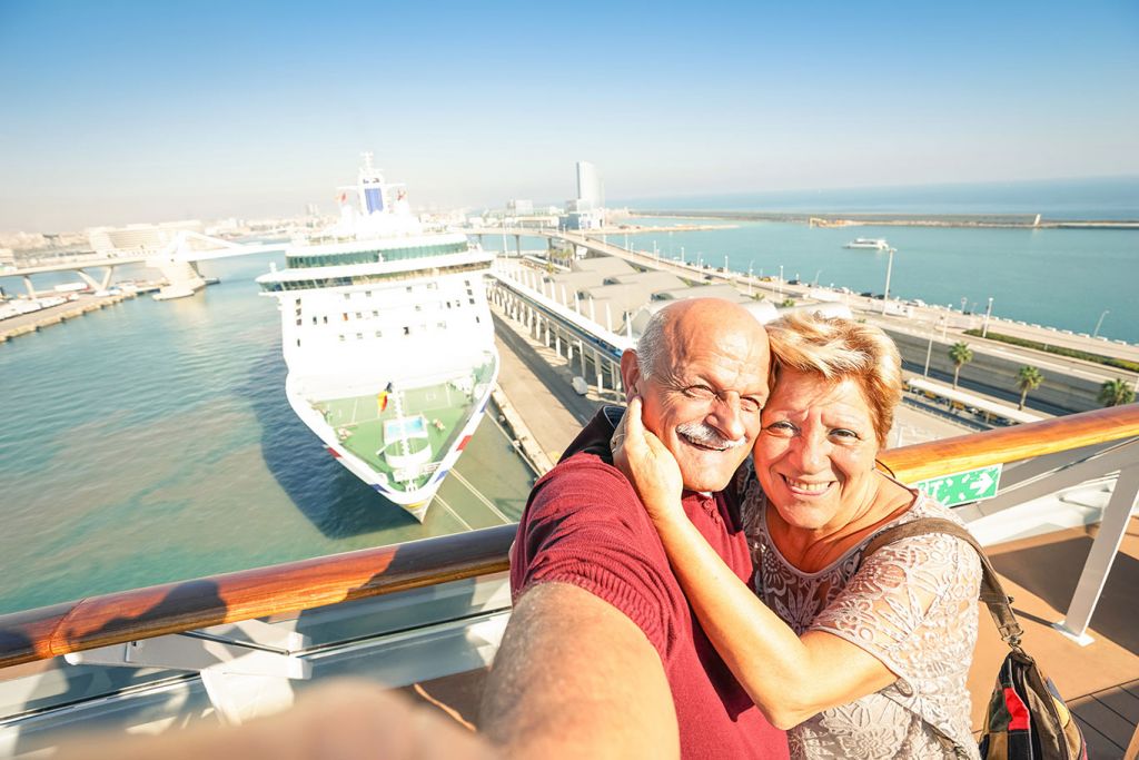 Older couple take photo on cruise holiday