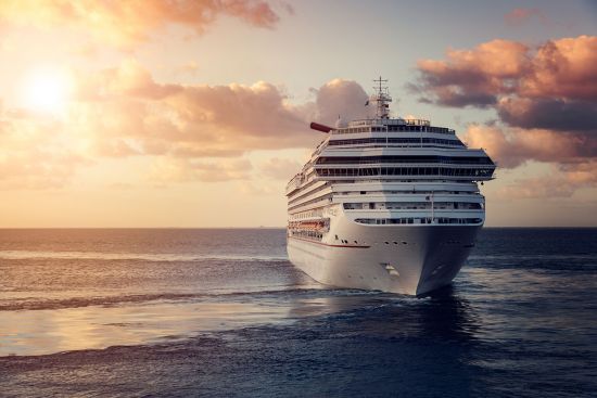 Cruise ship sailing into sunset