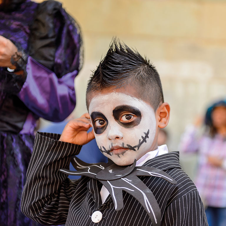 Boy dressed up with skeleton mask at Mexico festival